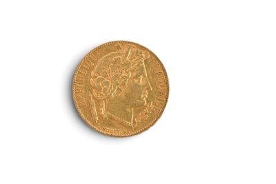 gros plan d'une pièce d'or sur une surface blanche