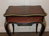 a small table with a red and black design on it
