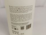 a close up of a bottle of liquid on a white surface
