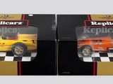 two toy cars that are in a box on a table