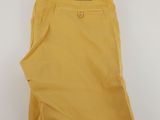 a pair of yellow pants sitting on top of a white surface