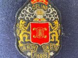 embroidered badge of a royal coat of arms with lions and a crown