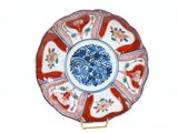 a red and white plate with a blue and white design on it