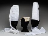 trois chapeaux avec des lacets blancs et un chapeau blanc posé sur une tête de mannequin