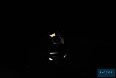 dark photo of a car in the dark with its headlights on