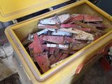 une grande caisse jaune remplie de briques et d'outils