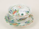 a small bowl and saucer on a saucer on a plate