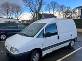 the white van is parked in the parking lot next to other cars