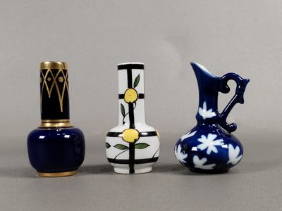 three small vases sitting next to each other on a table