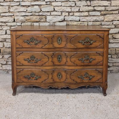 an antique chest of drawers with a marble top