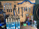 many tools hanging on the wall next to each other