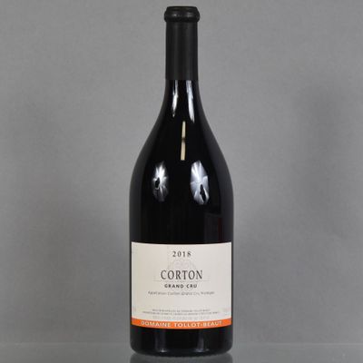 a bottle of red wine sitting on a table