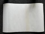 a piece of white paper on a black surface