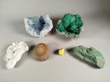 five different types of rocks on a white surface