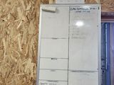 a white board on the wall in a room