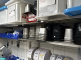 a kitchen with a lot of dishes and containers on the shelves