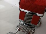 an image of a red barber chair with a foot rest