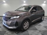 the front end of a grey car that is sitting on a checkered floor