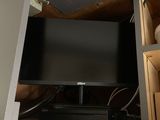 a flat screen tv sitting on top of a cabinet