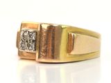 an image of a gold and diamond ring on a white surface