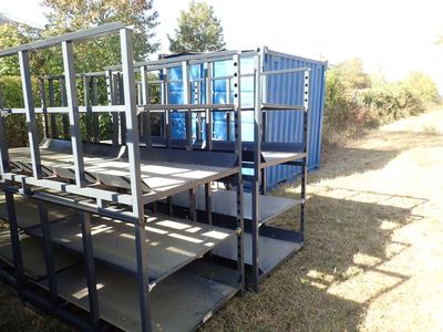 a blue container sitting on the ground next to a set of stairs