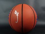 a close up of a basketball on a black background