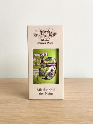 a box of tea sitting on top of a wooden table