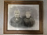an old photo of a man and a woman posing for a picture