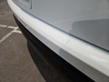 a white car that is parked in a parking lot