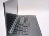 a laptop that is open on a white surface