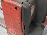 a forklift with a red seat on it in a warehouse