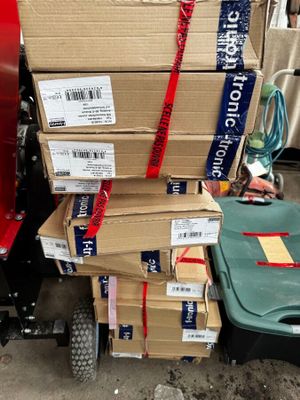 many boxes stacked on top of each other on a cart