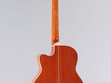 an acoustic guitar hanging from the back of a white wall