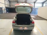 a silver car with its trunk open in a garage
