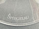 a close up of a glass plate with a name on it