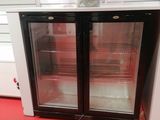 two refrigerators that are sitting on the floor in a store
