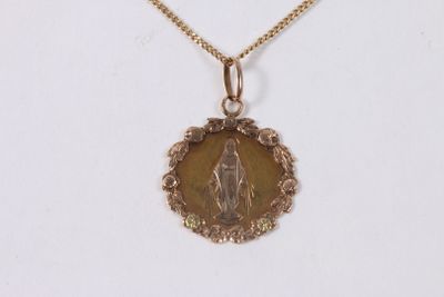 an image of a gold necklace with a picture of the virgin of guadalupe