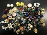 a close up of a pile of assorted jewelry on a table