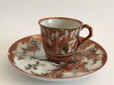 a cup and saucer on a saucer on a white table