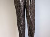 the mannequin is standing on a metal stand with a black top and silver pants