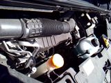 a close up of a car ' s engine with its hood open
