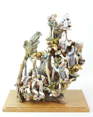 a figurine of a group of people sitting on a rock