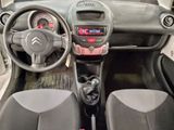 dashboard of a small car with a steering wheel and dashboard controls