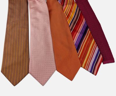 four different colored ties are arranged in a row on a white background
