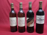 four bottles of wine are lined up on a red background