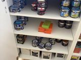 a shelf that has many different types of paint on it