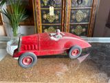 a red toy car sitting on top of a glass table