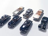 several toy cars are lined up in a row on a white surface