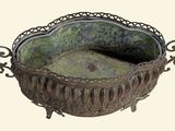 a metal bowl with a mossy surface on it