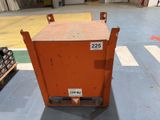 an orange box sitting on a pallet in a warehouse